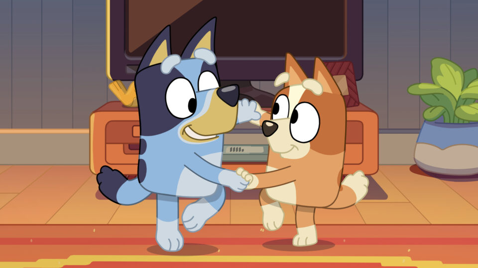 Bluey and bingo holding hands while dancing