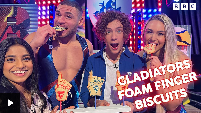 Steel the Gladiator with three Blue Peter presenters and Gladiator Foam Finger Biscuits