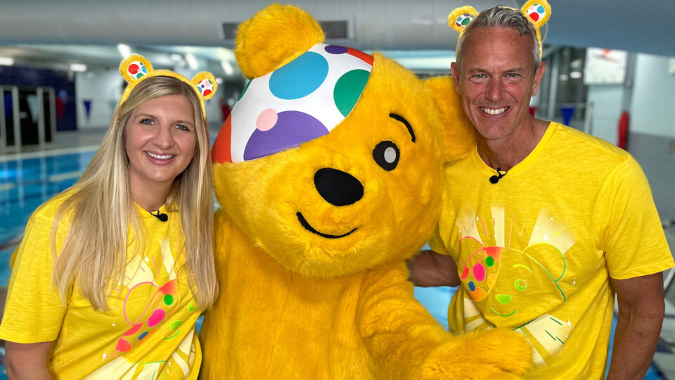 Rebecca Adlington and Mark Foster taking a photo with Pudsey Bear