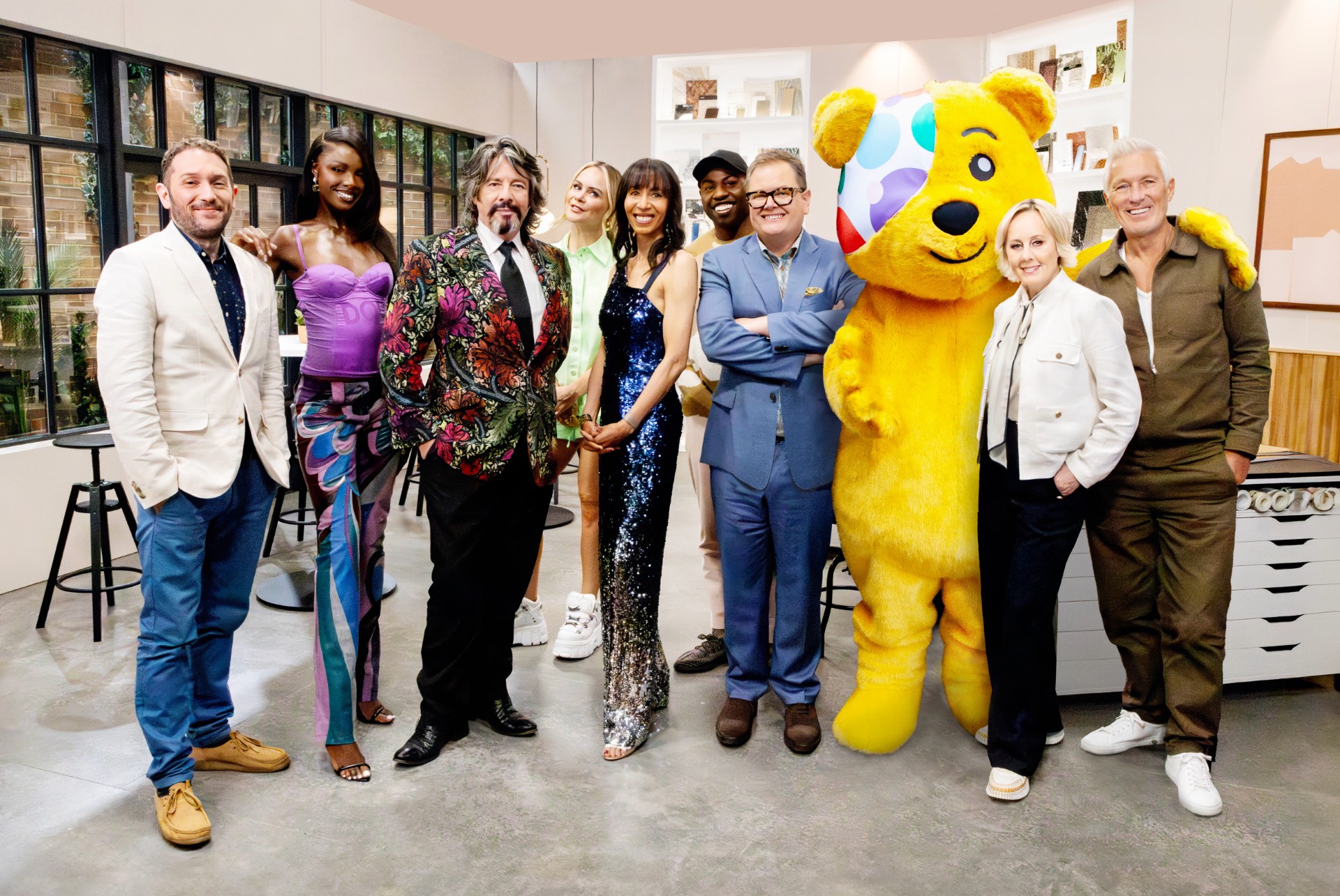 The celebrity participants of interior design masters smiling with Pudsey Bear