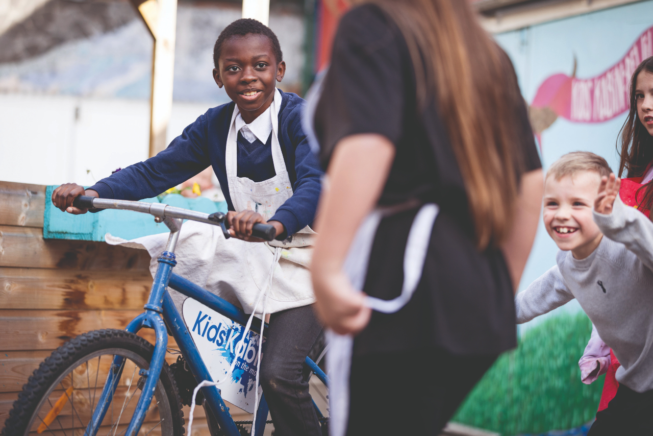 A child riding a bike smiling