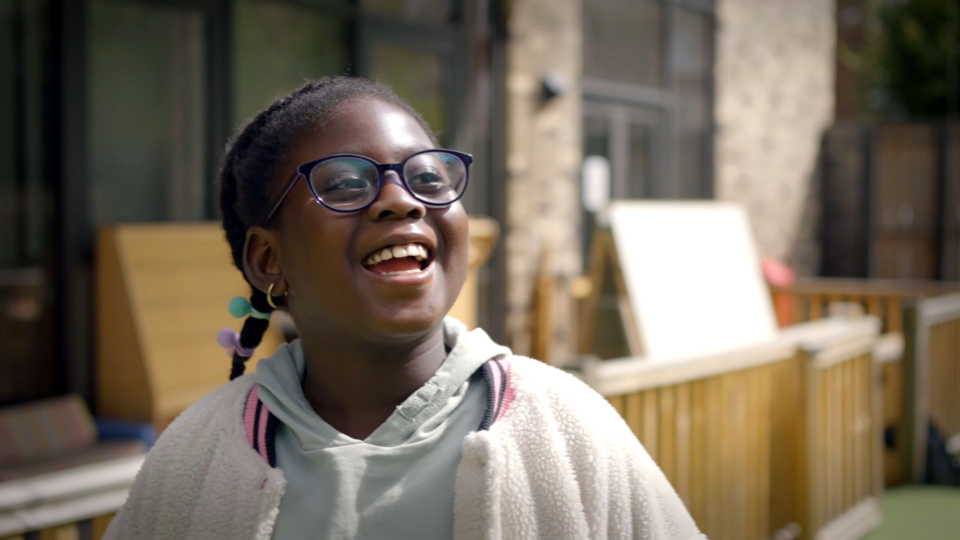 a child smiling in a playground