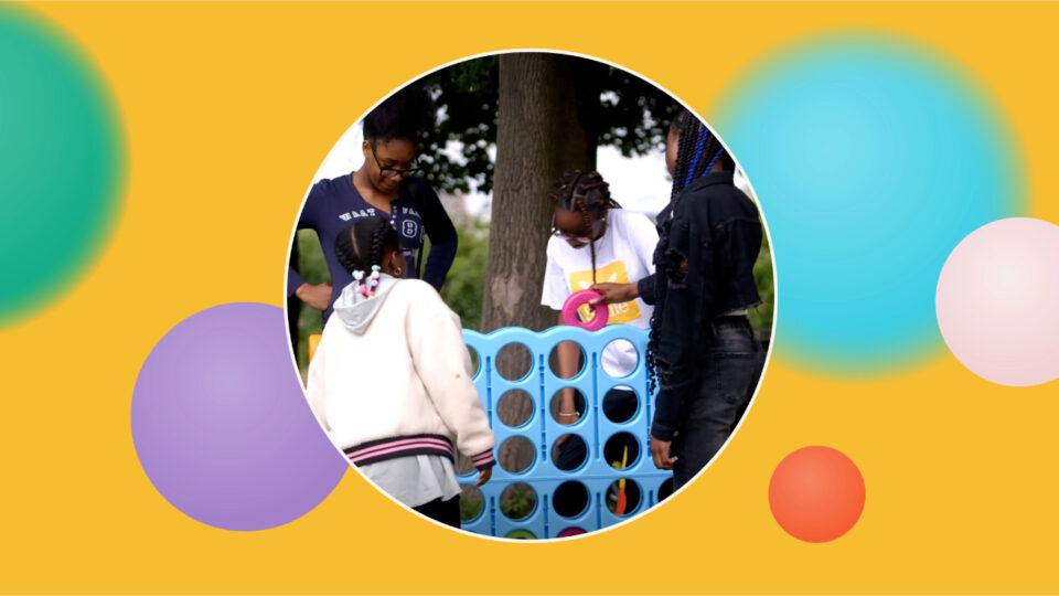 A giant Connect 4 game being played by children